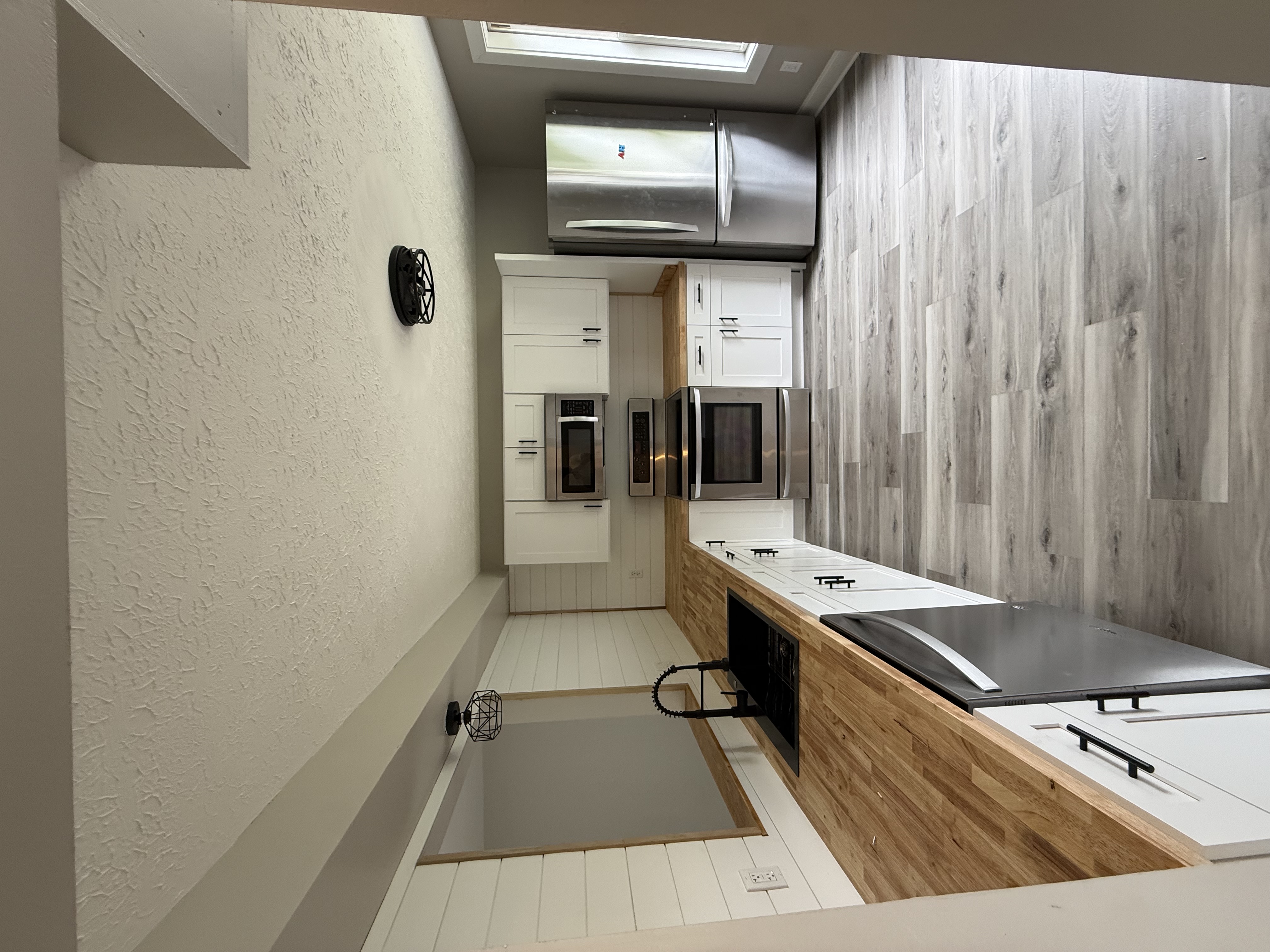 Kitchen remodel with white shaker cabinets and butcherblock countertops