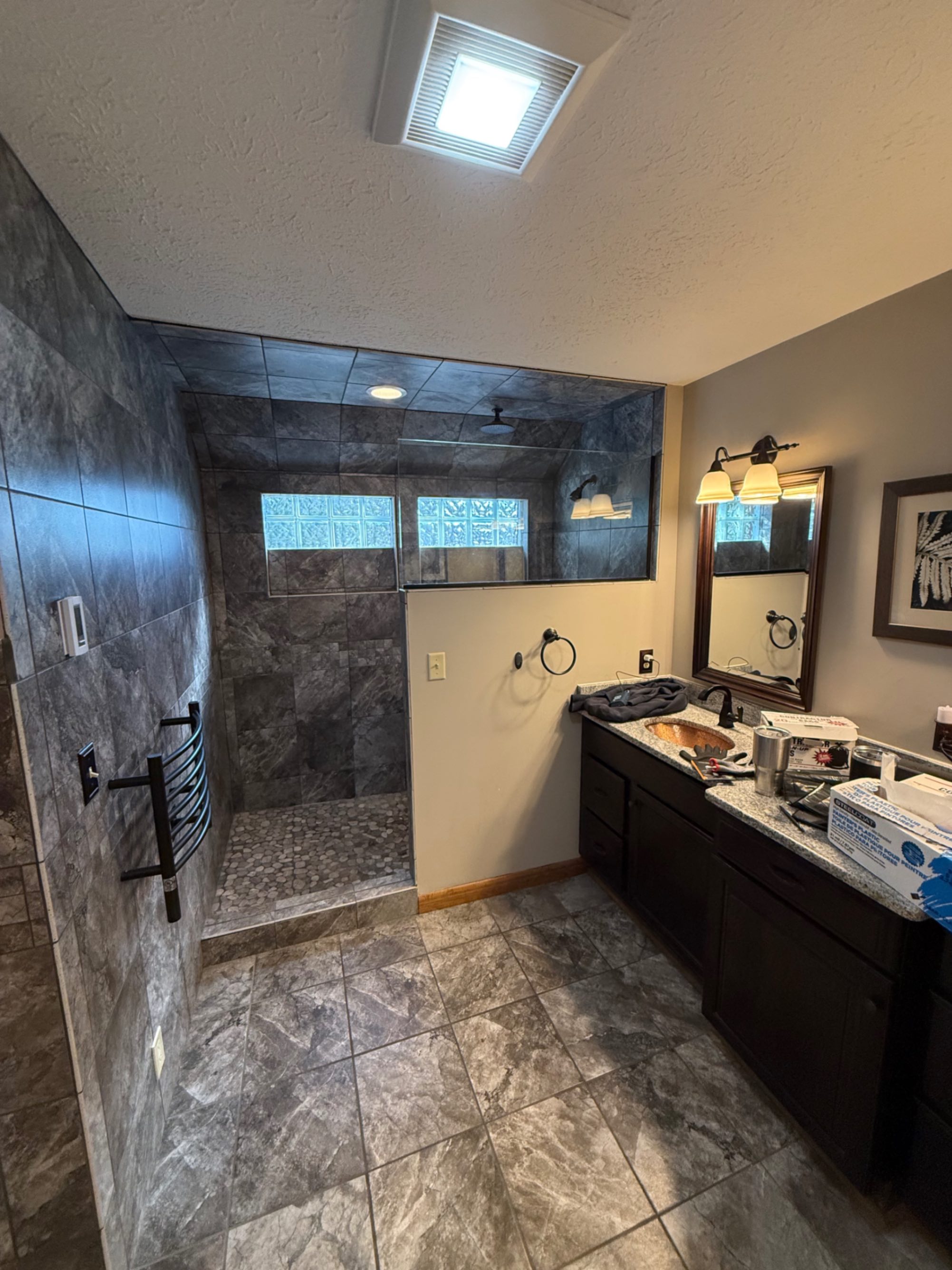 Bathroom before remodel — existing shower and vanity area