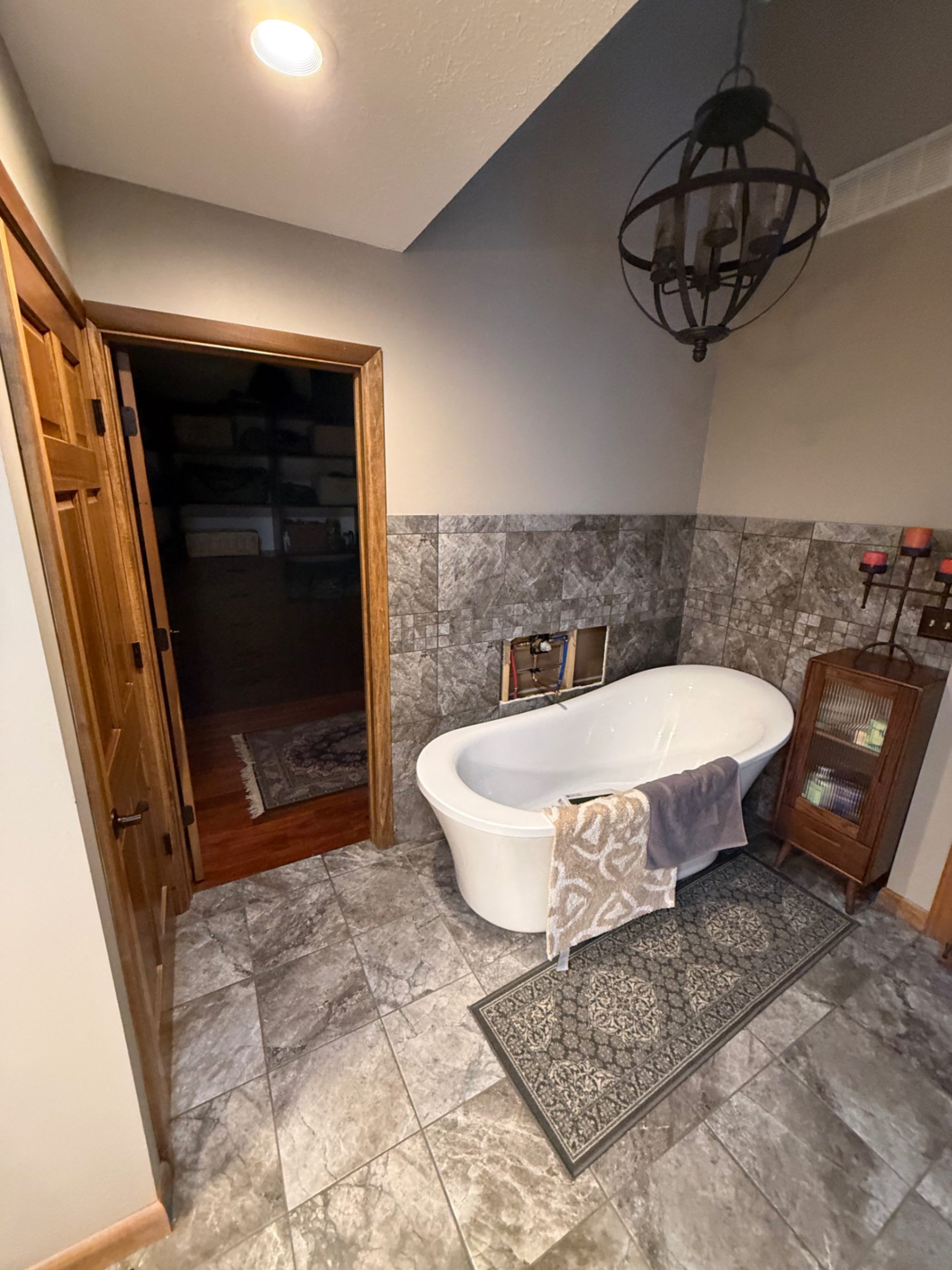 Bathroom before remodel — freestanding tub and tile surround